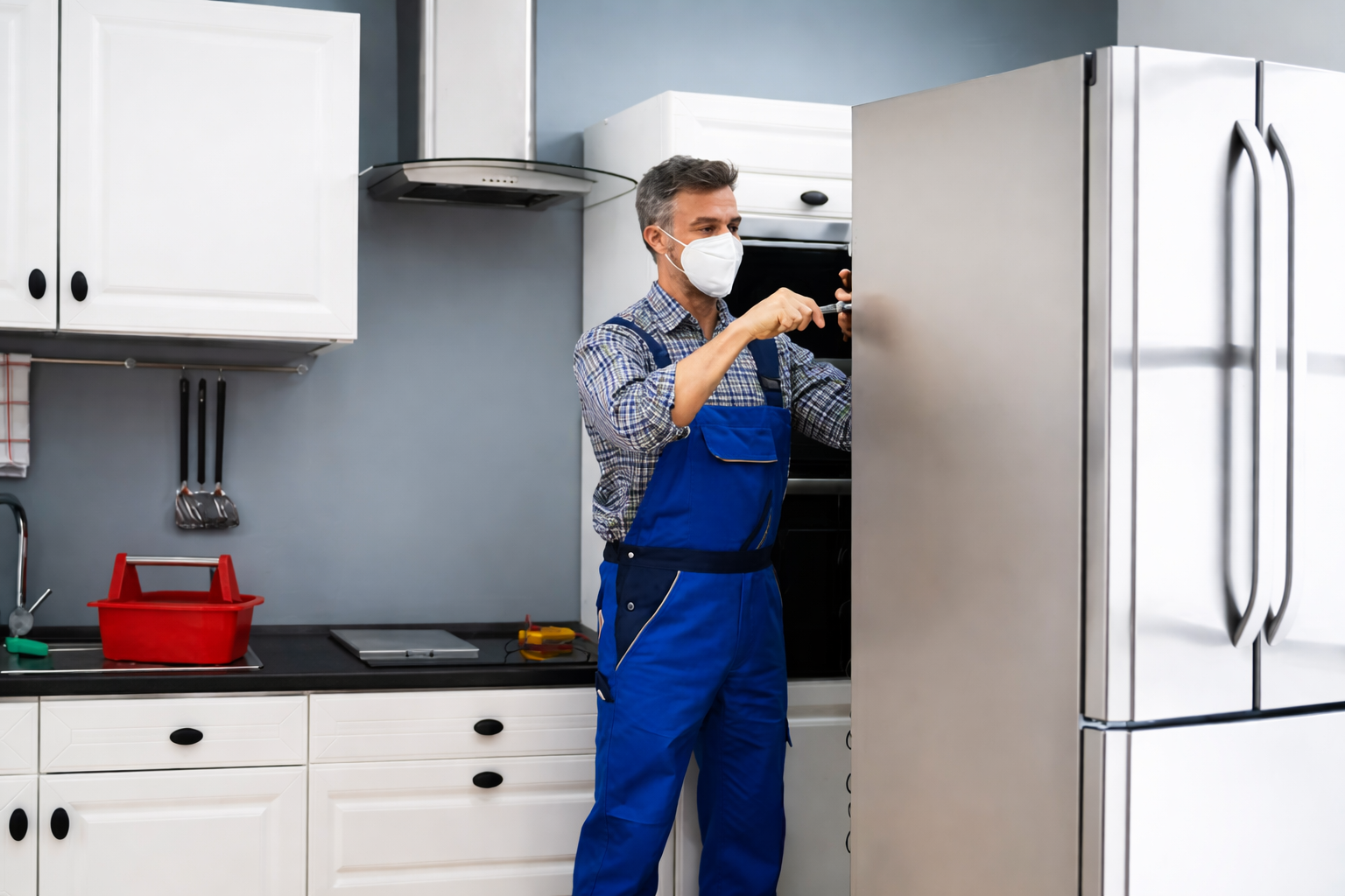 Technician repairing a refrigerator